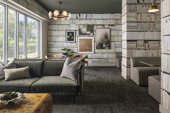A living room with a grey couch and a wooden coffee table.